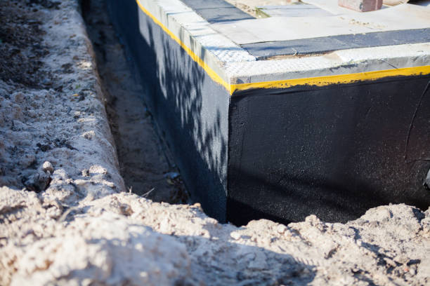 Professional Basement Waterproofing technician working in Portland, MI